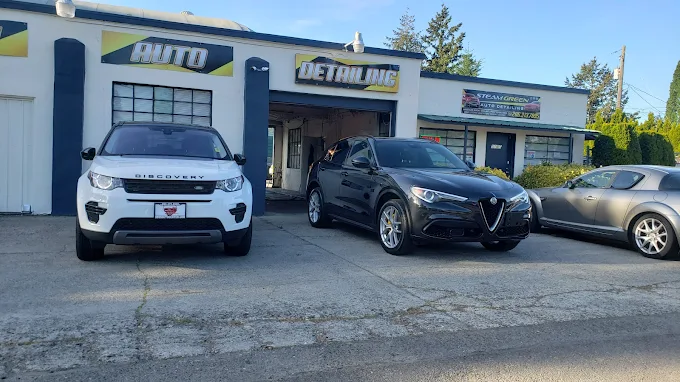 Land Rover Discovery and Alfa Romeo Stelvio outside the Steam Green shop