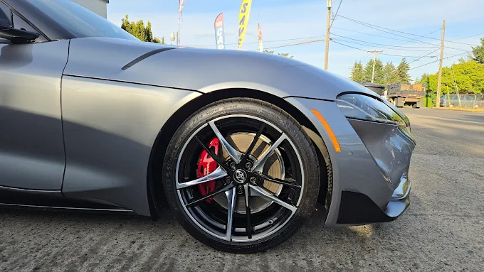 Close-up of a Supra wheel and brake caliper after detailing